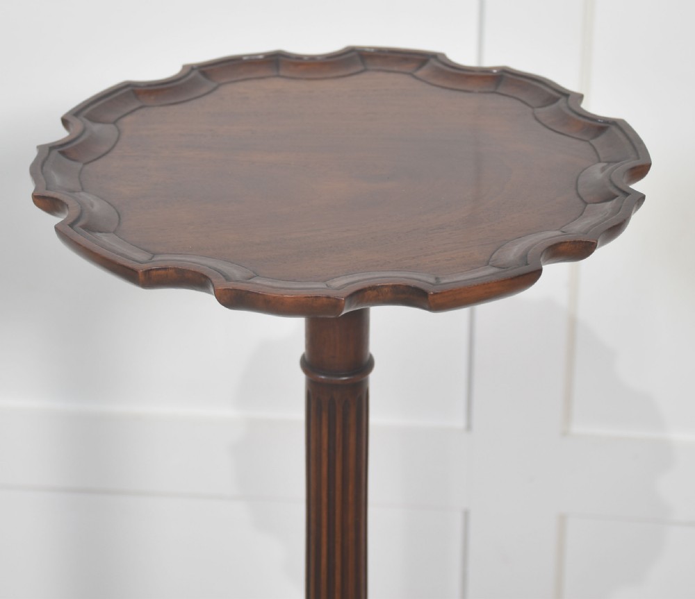 A tall mahogany tripod wine table featuring a scalloped piecrust rim, reeded column, and carved legs with ball and claw feet. View VIII
