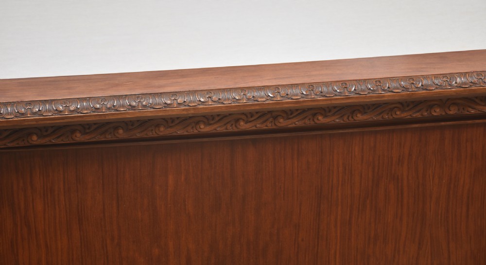 A carved mahogany super king size bed frame featuring architectural columns, a high headboard with flame mahogany panel, and carved decorative details. View IV