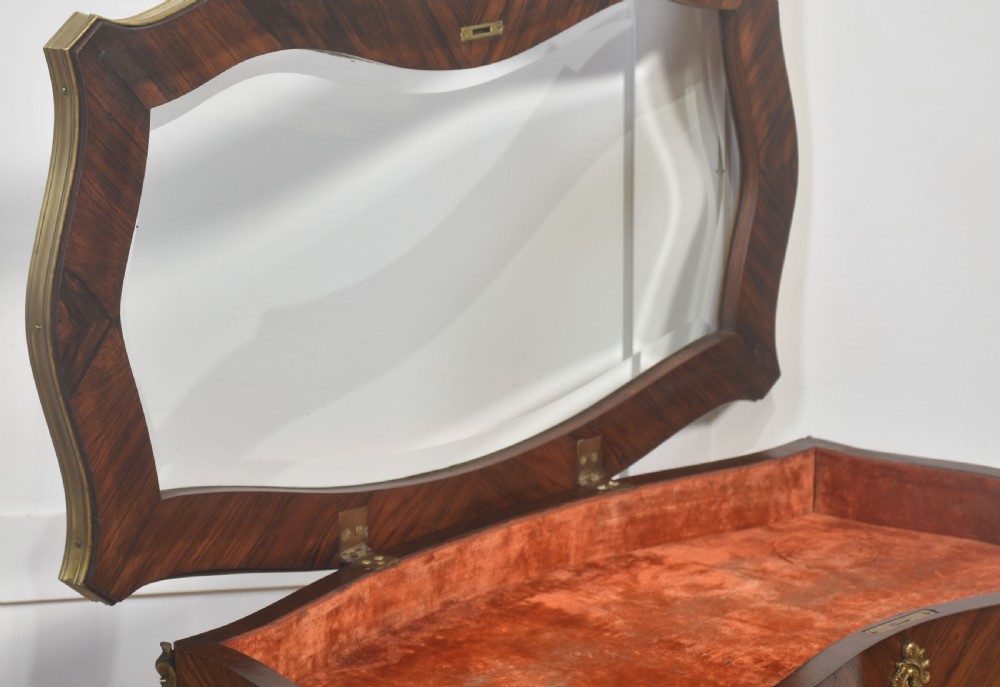 A French Louis XV style kingwood bijouterie table featuring a glazed display lid, curved aprons with gilt-bronze escutcheons, and slender cabriole legs with brass mounts. View XII