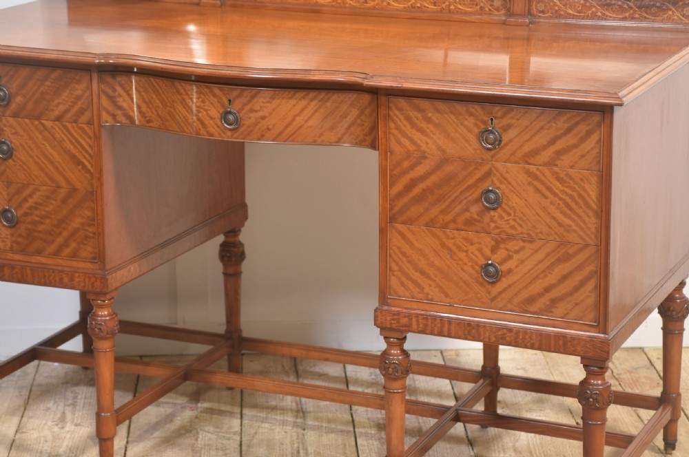 An antique satinwood dressing table featuring a triptych mirror, chevron marquetry drawers, brass ring handles, and turned legs on castors. View VI