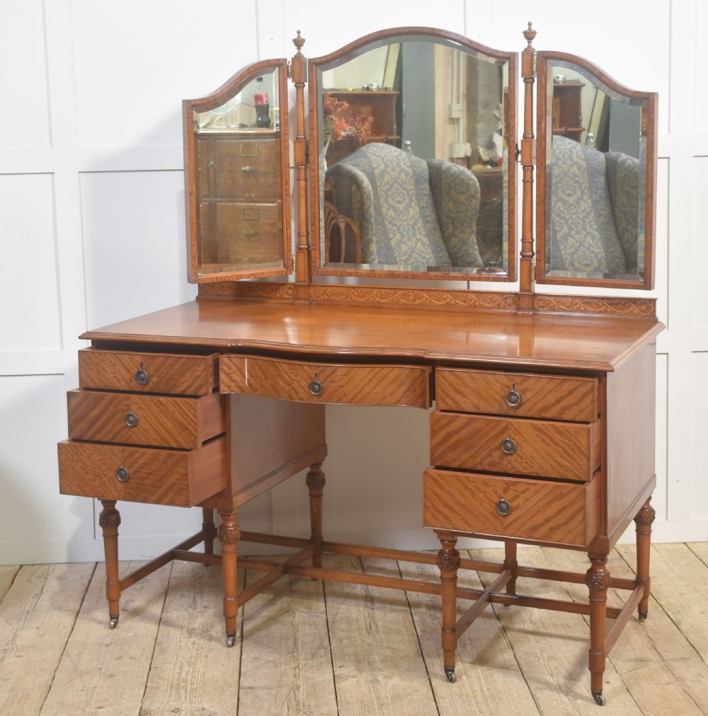 An antique satinwood dressing table featuring a triptych mirror, chevron marquetry drawers, brass ring handles, and turned legs on castors. View IX