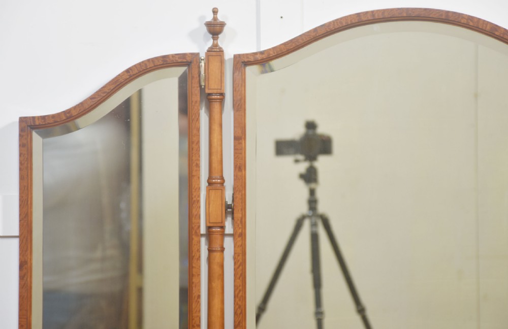 An antique satinwood dressing table featuring a triptych mirror, chevron marquetry drawers, brass ring handles, and turned legs on castors. View XI