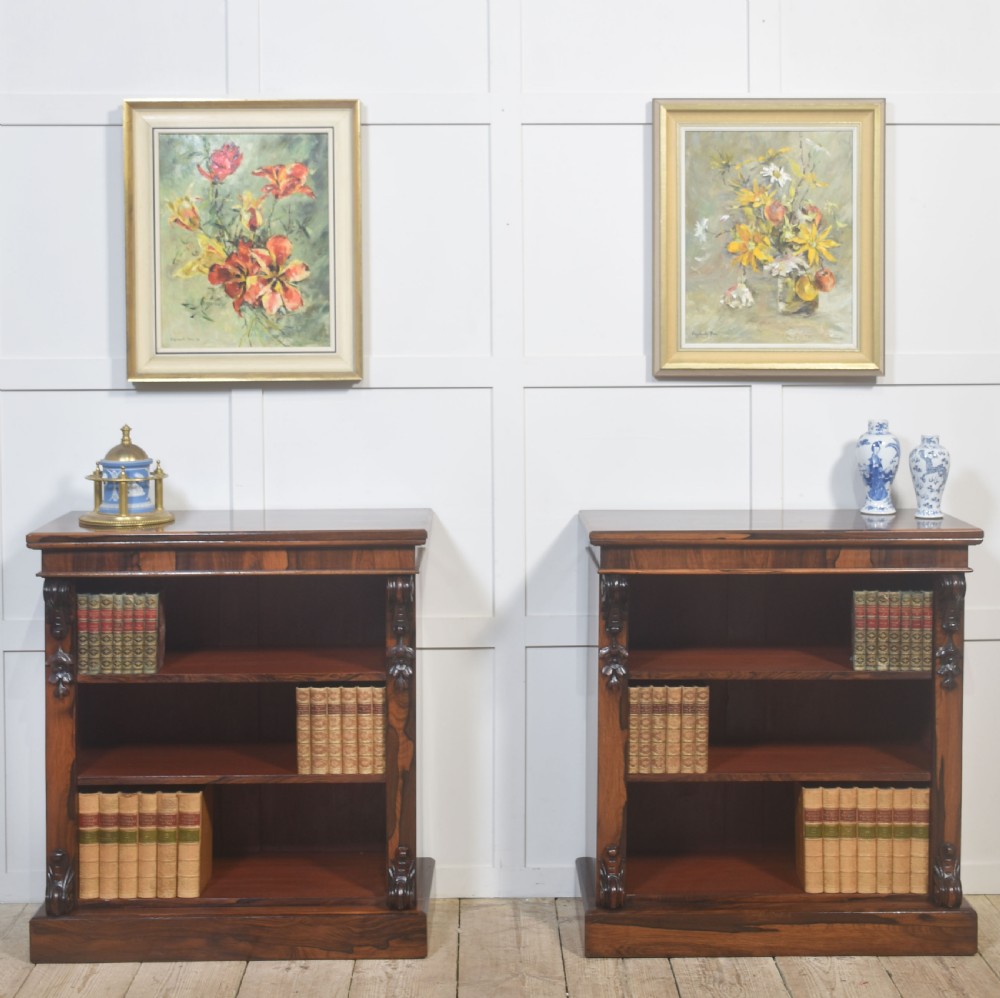 A pair of 19th-century rosewood open bookcases featuring carved side corbels and three open shelves each on a solid plinth base. View III