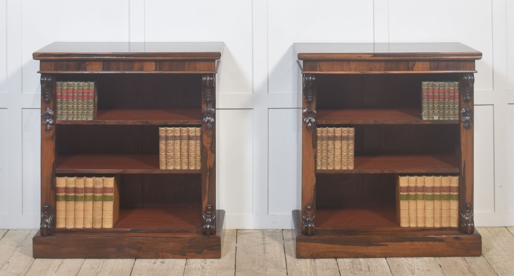 A pair of 19th-century rosewood open bookcases featuring carved side corbels and three open shelves each on a solid plinth base. View IV