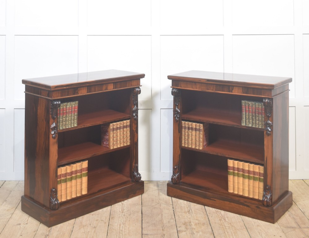 A pair of 19th-century rosewood open bookcases featuring carved side corbels and three open shelves each on a solid plinth base. View VII