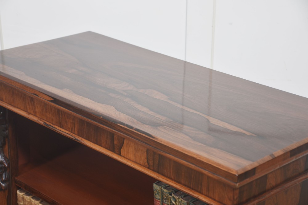 A pair of 19th-century rosewood open bookcases featuring carved side corbels and three open shelves each on a solid plinth base. View VIII