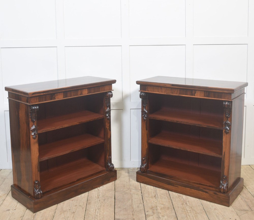 A pair of 19th-century rosewood open bookcases featuring carved side corbels and three open shelves each on a solid plinth base. View XII