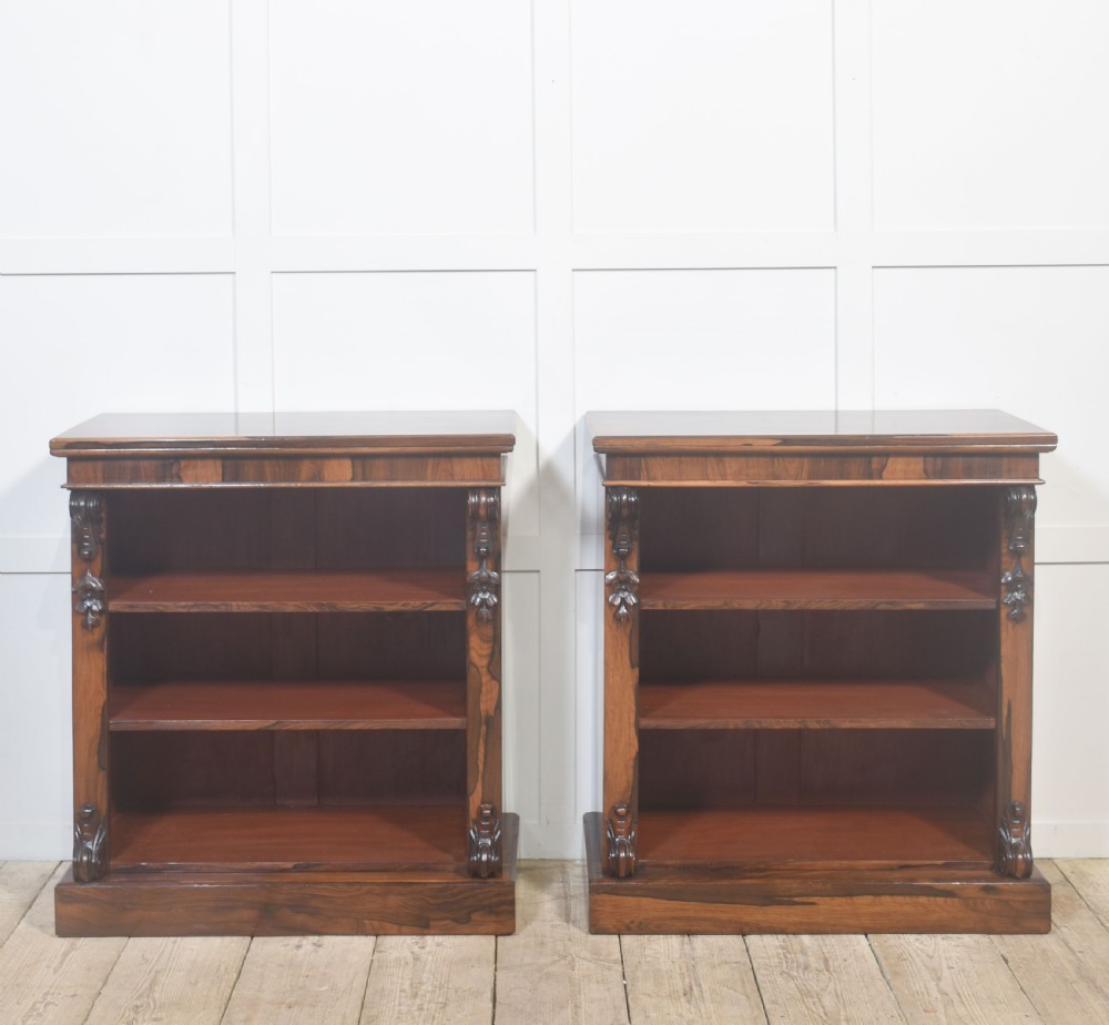 A pair of 19th-century rosewood open bookcases featuring carved side corbels and three open shelves each on a solid plinth base. View XIV
