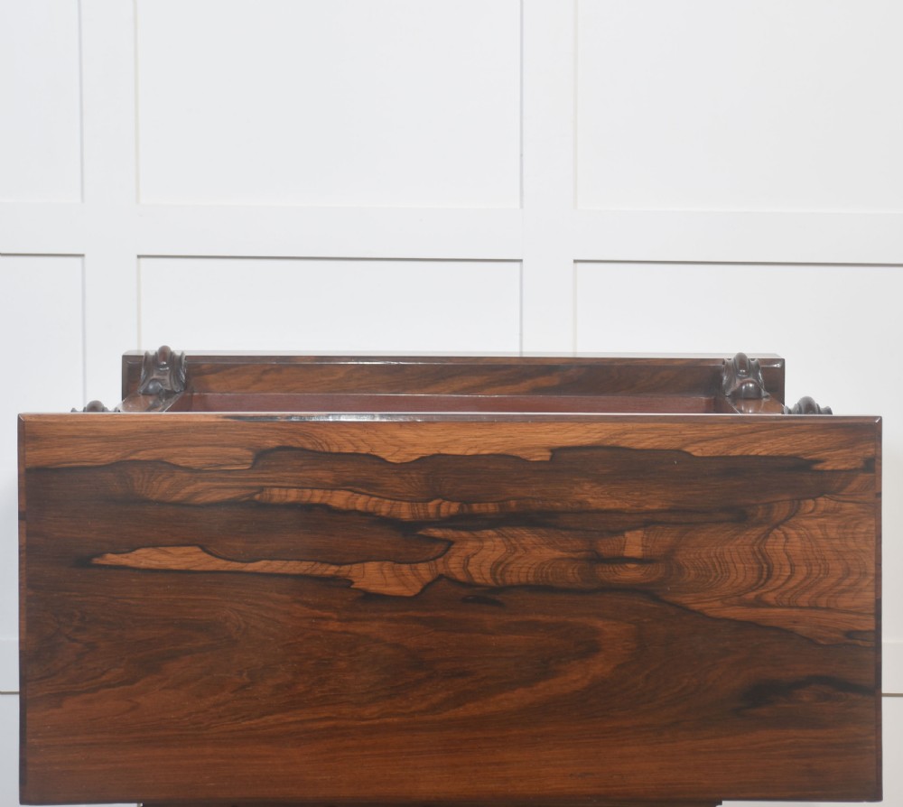 A pair of 19th-century rosewood open bookcases featuring carved side corbels and three open shelves each on a solid plinth base. View XV