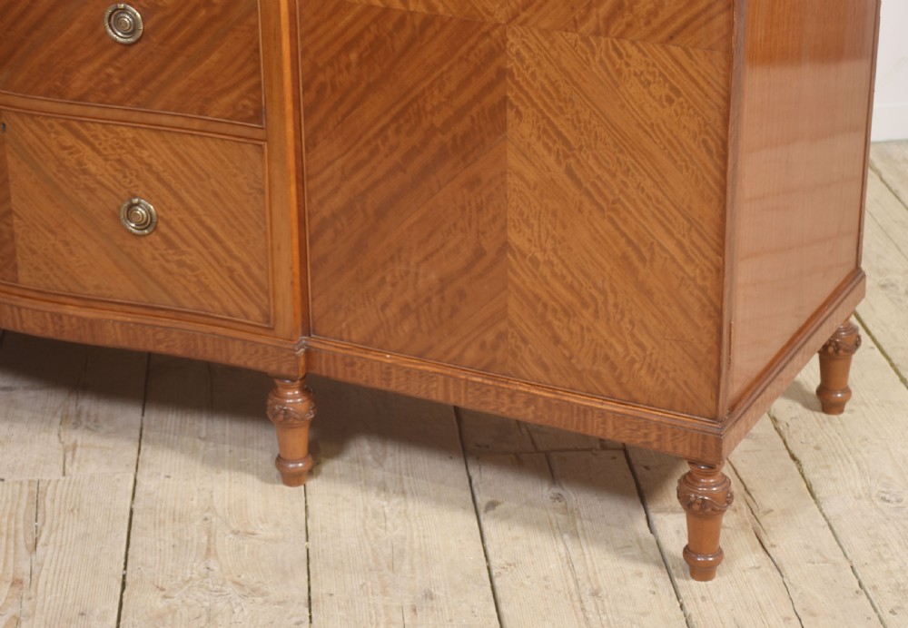 A large Edwardian inlaid satinwood compactum wardrobe featuring a central section with cupboard doors above four drawers, flanked by two full-length side doors. View IX