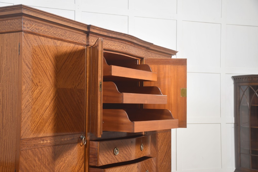A large Edwardian inlaid satinwood compactum wardrobe featuring a central section with cupboard doors above four drawers, flanked by two full-length side doors. View XVI