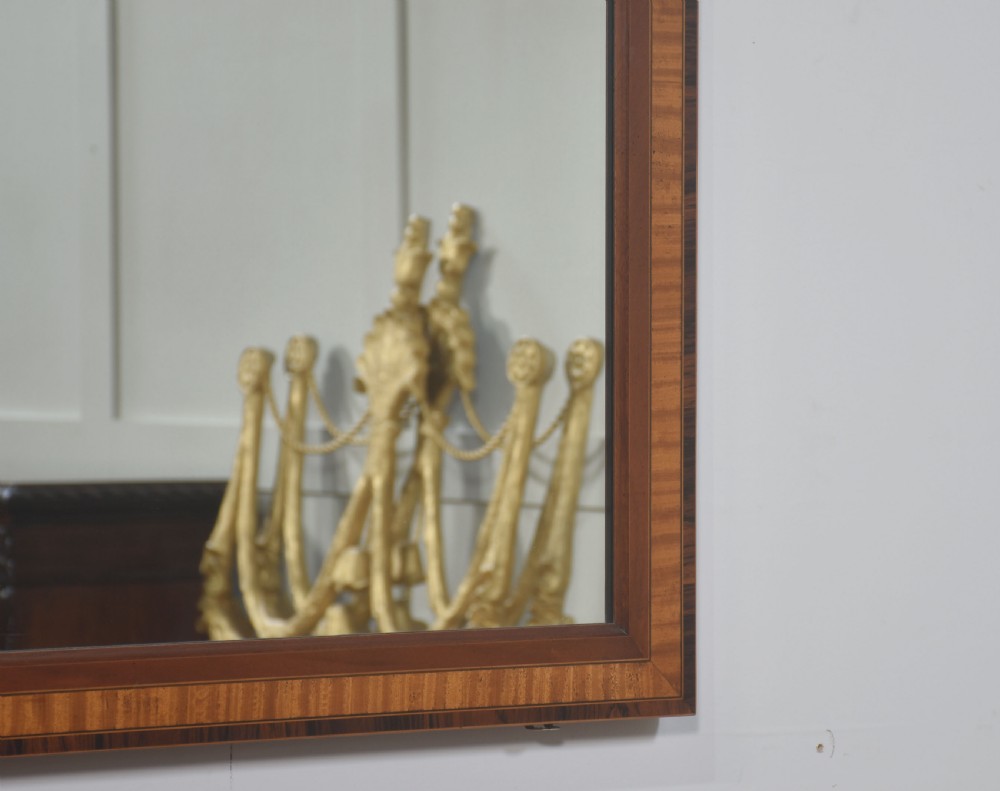 A demilune inlaid mahogany console table with square tapered legs shown beneath a matching rectangular crossbanded mahogany wall mirror. View VI