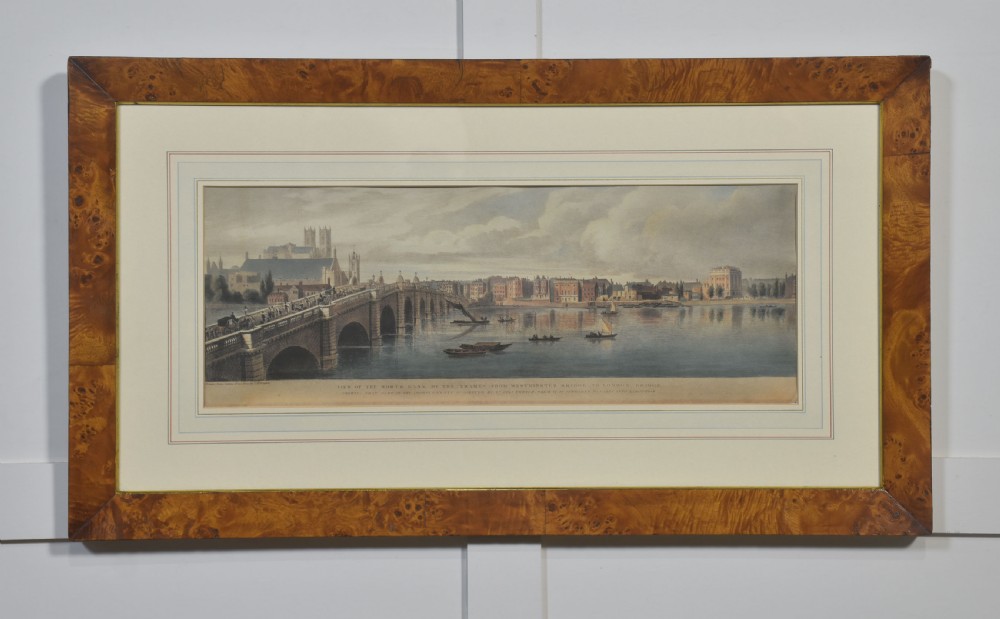 A set of six matching framed rectangular prints displaying panoramic views of the River Thames set within rich burr walnut frames with light cream mounts. View X