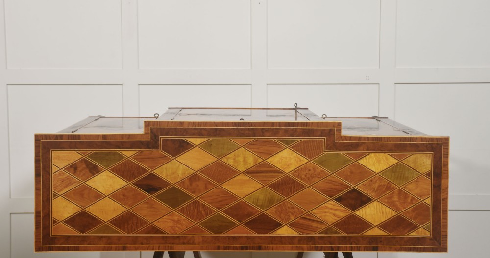 A Sheraton Revival satinwood sideboard with three upper drawers and three cupboard doors featuring oval marquetry panels of flowers and urns. View X