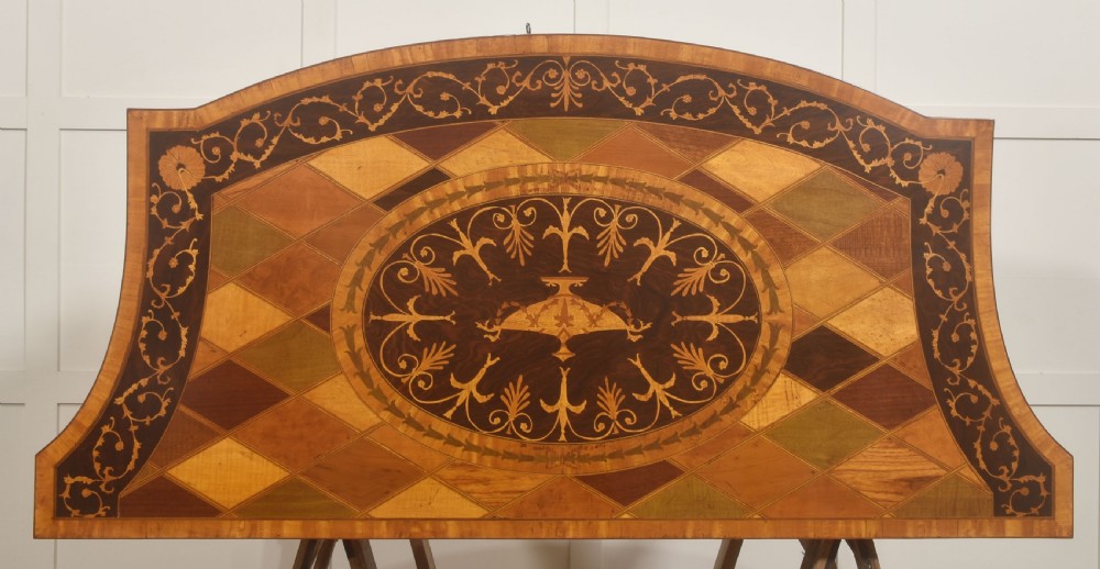 A George III style satinwood and rosewood marquetry sideboard featuring oval cabinet doors with inlaid urn medallions, floral swags, and tapered square legs. View XIII