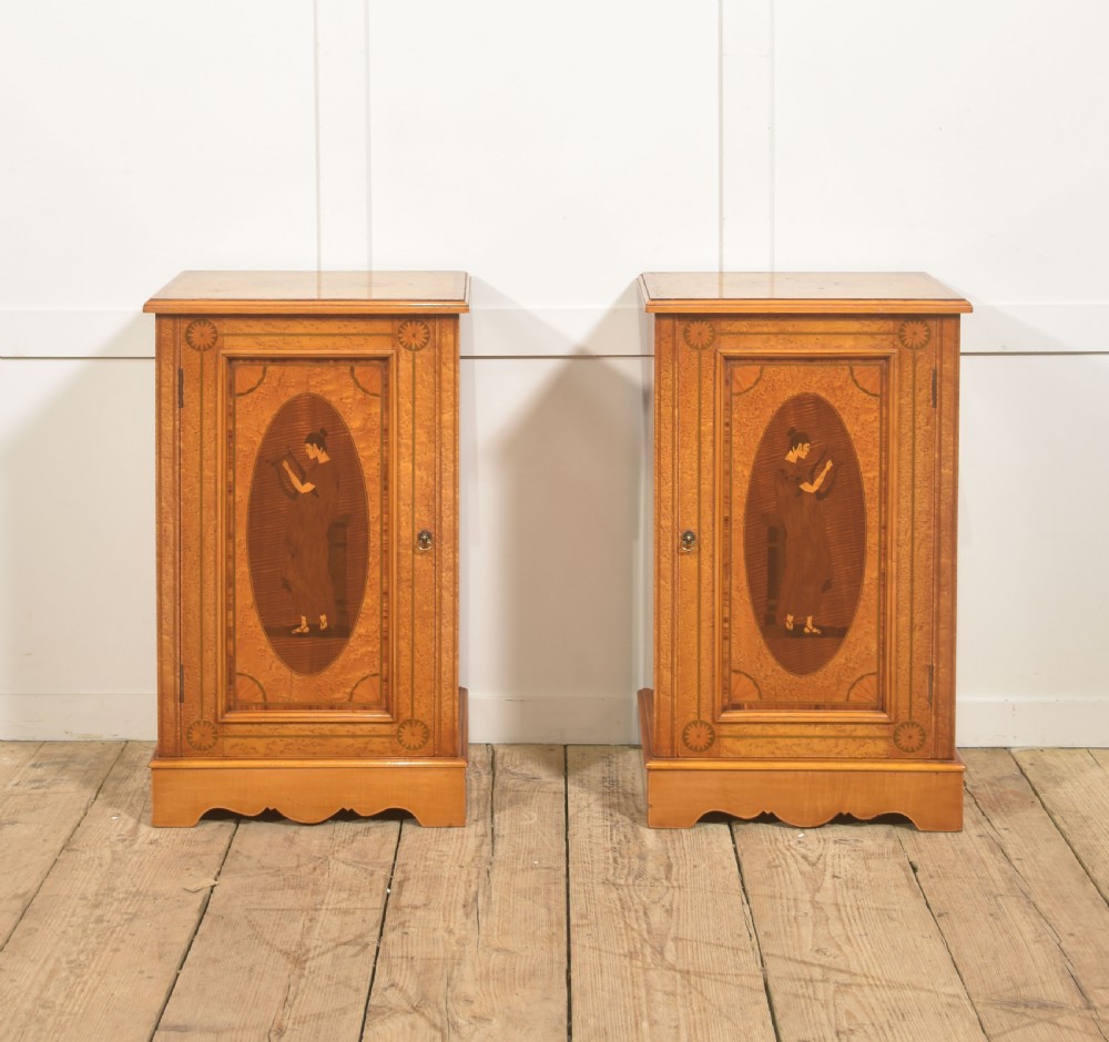 A pair of golden satinwood Neo-Classical Revival bedside cabinets featuring oval marquetry panels depicting classical figures playing instruments.