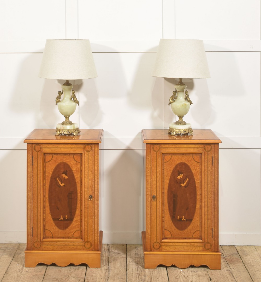 A pair of golden satinwood Neo-Classical Revival bedside cabinets featuring oval marquetry panels depicting classical figures playing instruments. View II