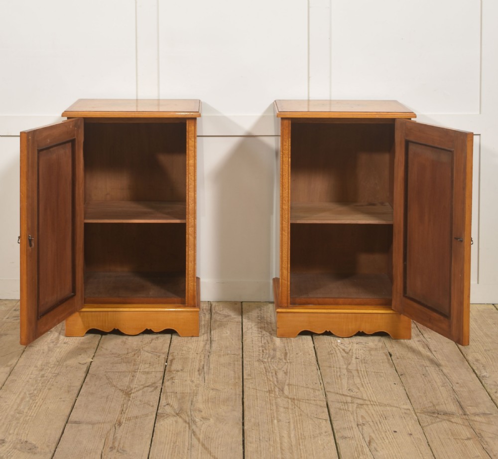 A pair of golden satinwood Neo-Classical Revival bedside cabinets featuring oval marquetry panels depicting classical figures playing instruments. View V