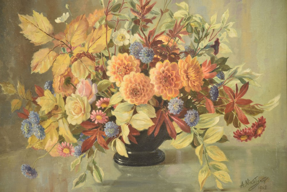 A framed oil painting on canvas depicting a still life arrangement of orange and yellow autumn flowers in a dark vase set within an ornate carved gilt frame. View III