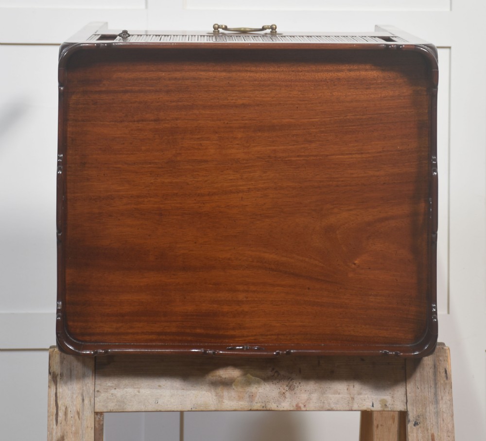 A pair of dark warm mahogany bedside cabinets featuring gallery tops with cutout handles, reeded tambour doors, and single lower drawers with brass handles. View VIII