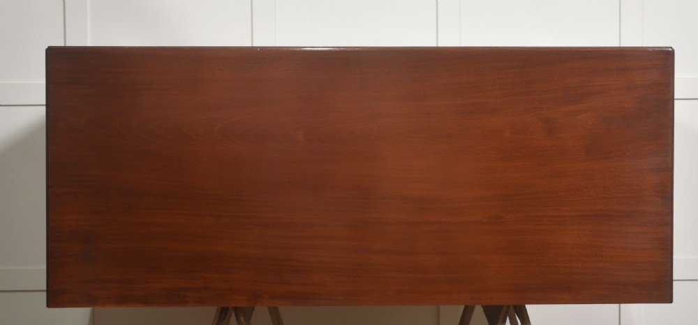 A Georgian style mahogany filing cabinet featuring a bank of multiple small drawers with brass swan-neck handles on a bracket foot base. View XVI