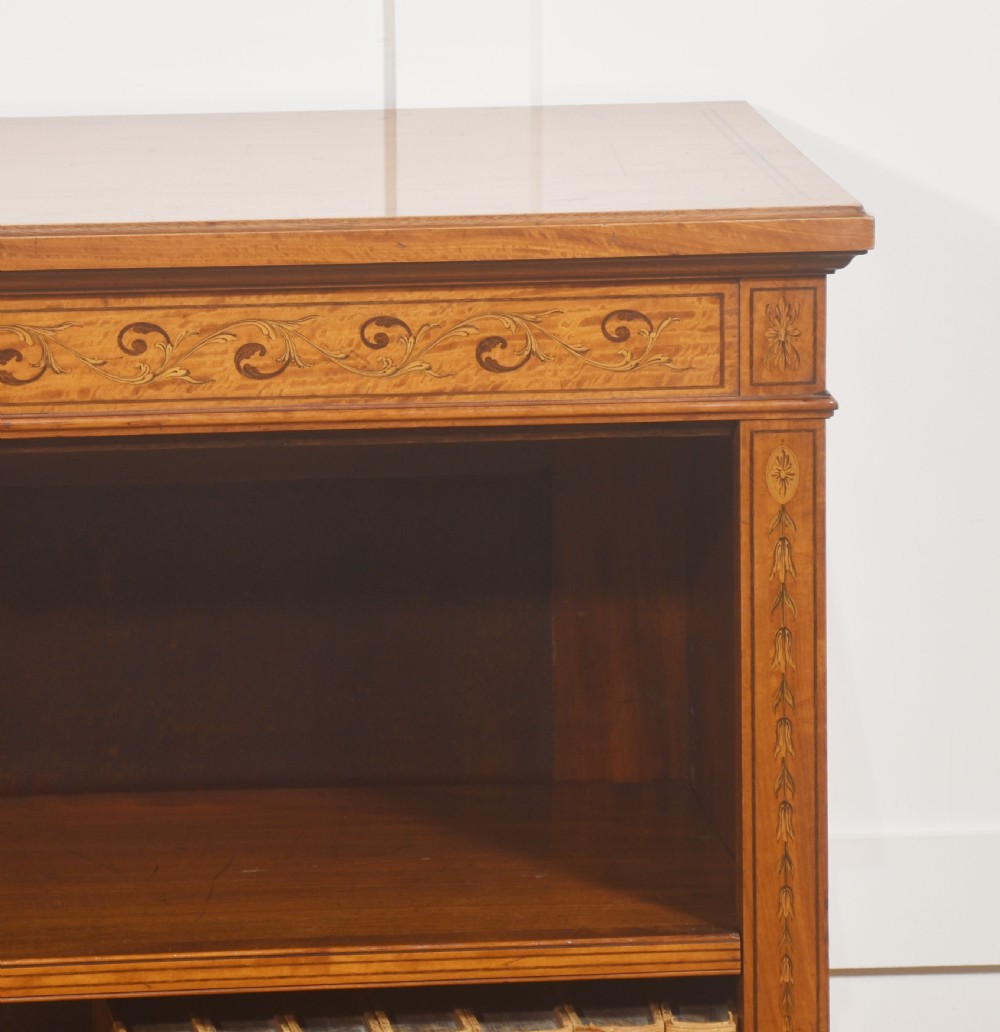 A low satinwood open bookcase featuring three shelves and a decorative inlaid floral frieze across the top. View IV