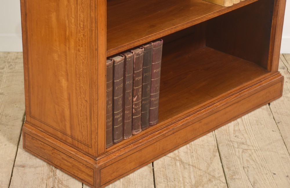 A low satinwood open bookcase featuring three shelves and a decorative inlaid floral frieze across the top. View VII