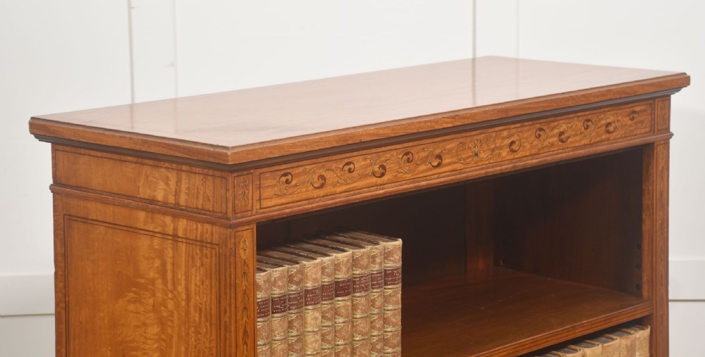 A low satinwood open bookcase featuring three shelves and a decorative inlaid floral frieze across the top. View VIII