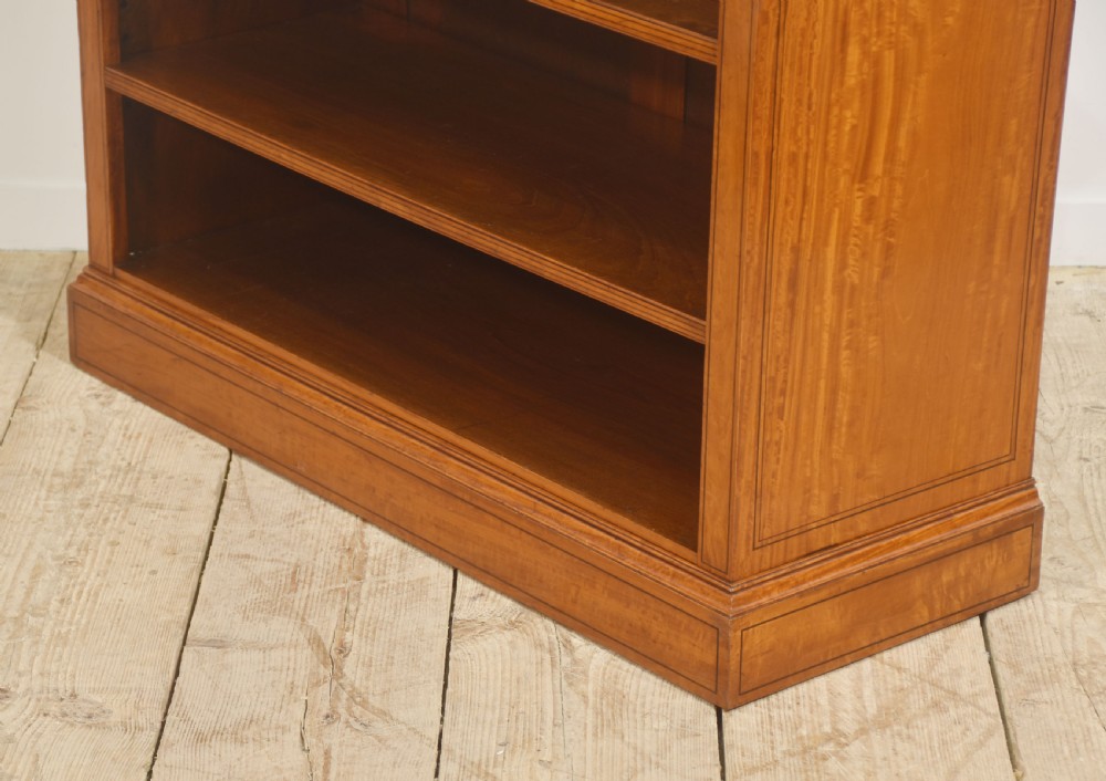 A low satinwood open bookcase featuring three shelves and a decorative inlaid floral frieze across the top. View XII