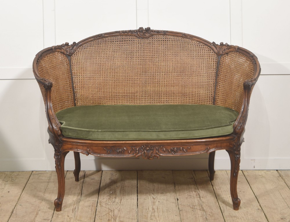  Louis XV–Style Carved Walnut Caned Settee