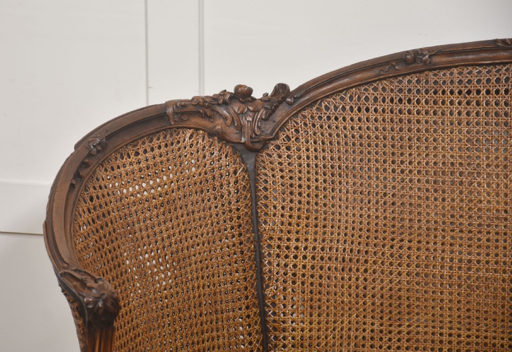  Louis XV–Style Carved Walnut Caned Settee View IV