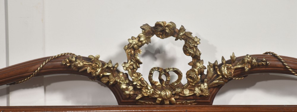 A Louis XVI style mahogany double bed frame featuring decorative parquetry veneer panels and polished gilt bronze mounts. View III