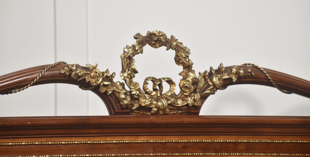 A Louis XVI style mahogany double bed frame featuring decorative parquetry veneer panels and polished gilt bronze mounts. View X
