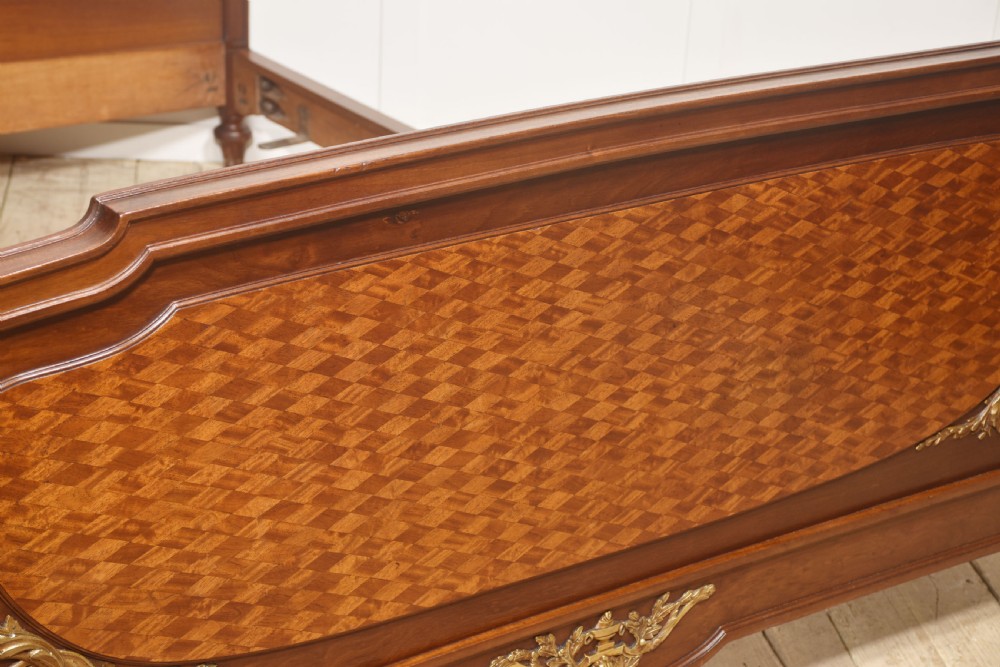 A Louis XVI style mahogany double bed frame featuring decorative parquetry veneer panels and polished gilt bronze mounts. View XI
