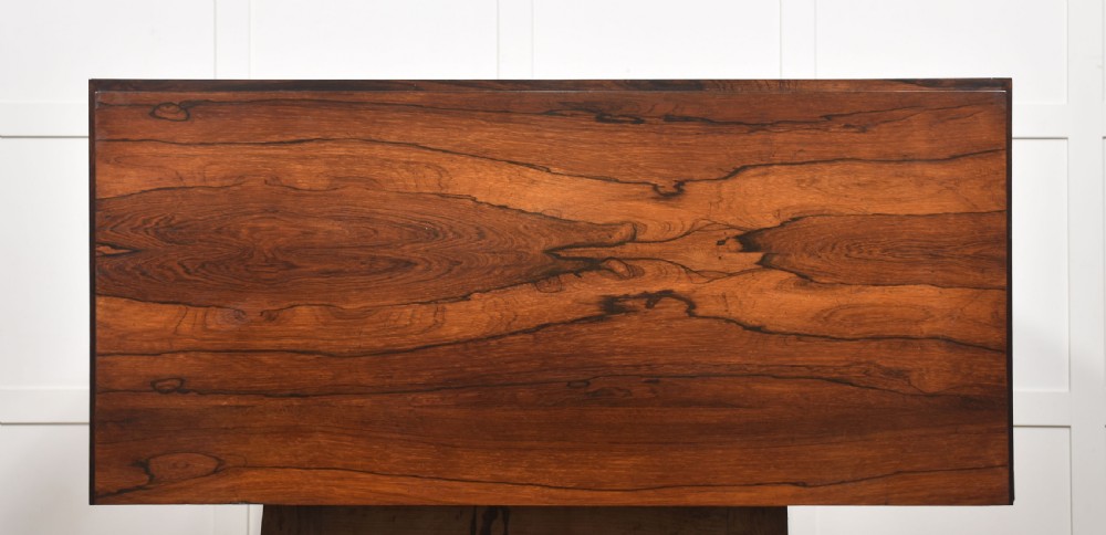A 19th-century dark rosewood glazed low bookcase featuring two arched glass doors, fluted side pilasters, and carved mouldings. View XXI