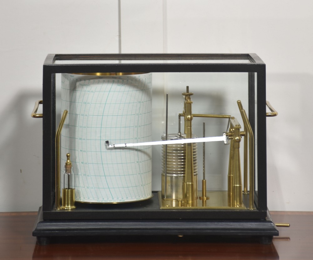 An antique Short and Mason aneroid barograph housed in a black glazed wooden case with brass carrying handles and internal mechanism.