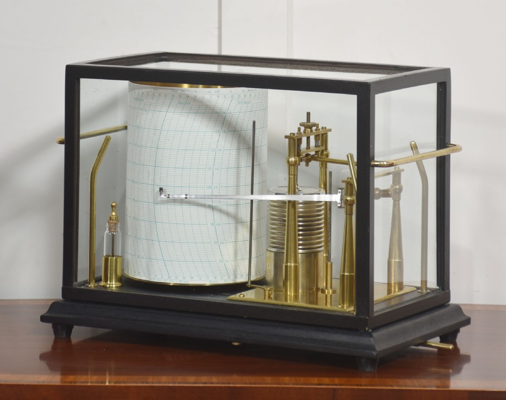 An antique Short and Mason aneroid barograph housed in a black glazed wooden case with brass carrying handles and internal mechanism. View II