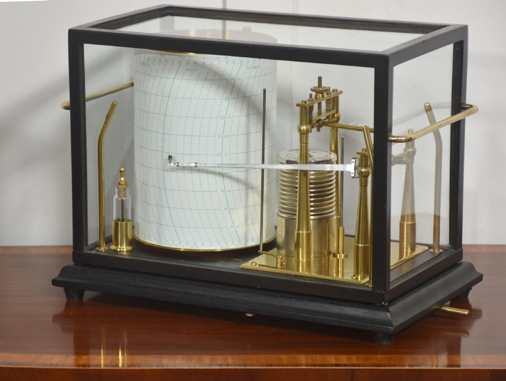 An antique Short and Mason aneroid barograph housed in a black glazed wooden case with brass carrying handles and internal mechanism. View III