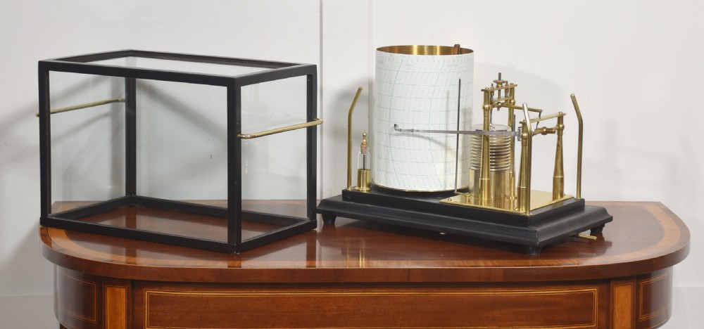 An antique Short and Mason aneroid barograph housed in a black glazed wooden case with brass carrying handles and internal mechanism. View V
