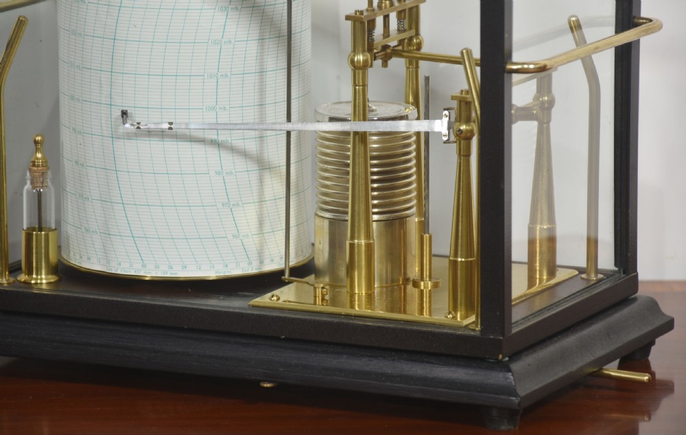 An antique Short and Mason aneroid barograph housed in a black glazed wooden case with brass carrying handles and internal mechanism. View VI