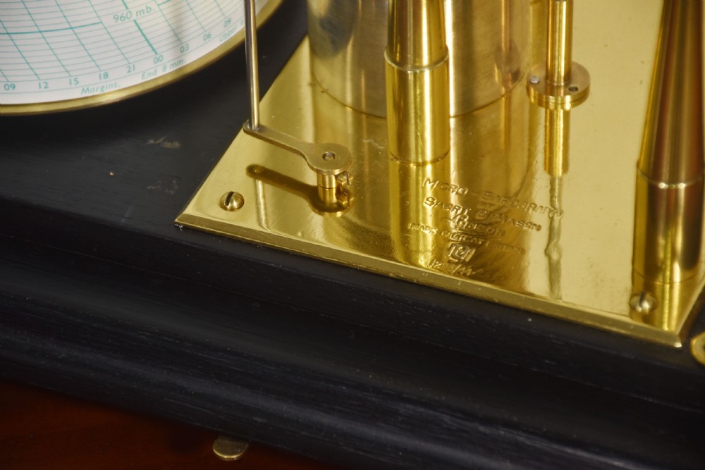 An antique Short and Mason aneroid barograph housed in a black glazed wooden case with brass carrying handles and internal mechanism. View VIII