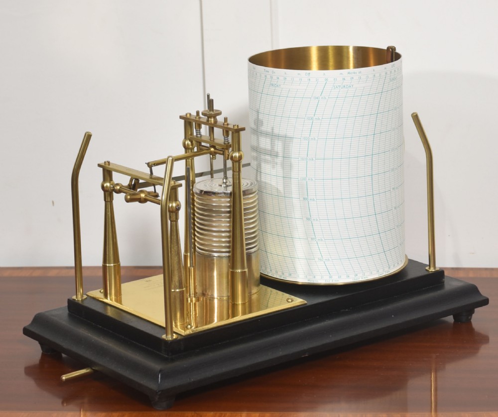 An antique Short and Mason aneroid barograph housed in a black glazed wooden case with brass carrying handles and internal mechanism. View X
