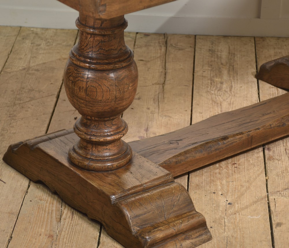 Solid oak refectory dining table featuring thick timber top, bulbous turned baluster pedestals, and a floor stretcher rail. View VIII