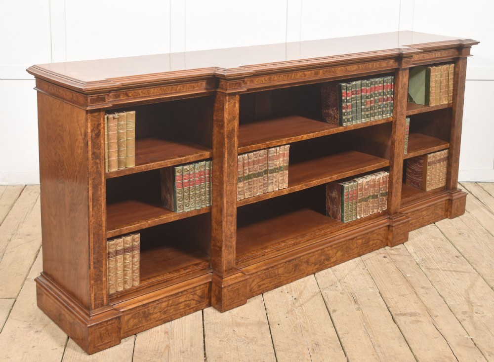 A low three-section breakfront open bookcase made from burr walnut veneer with adjustable shelves and a plinth base. View III