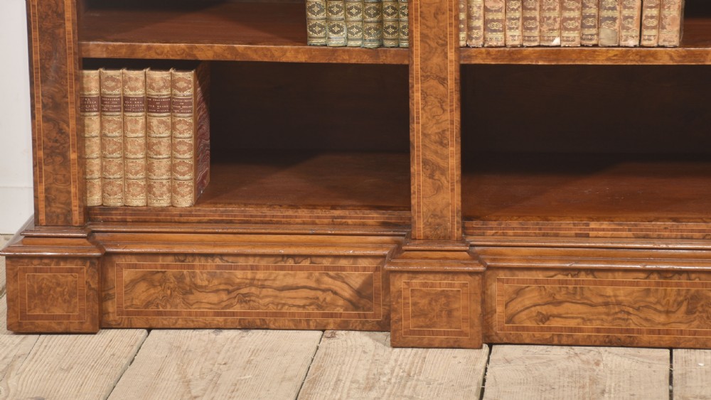 A low three-section breakfront open bookcase made from burr walnut veneer with adjustable shelves and a plinth base. View IV