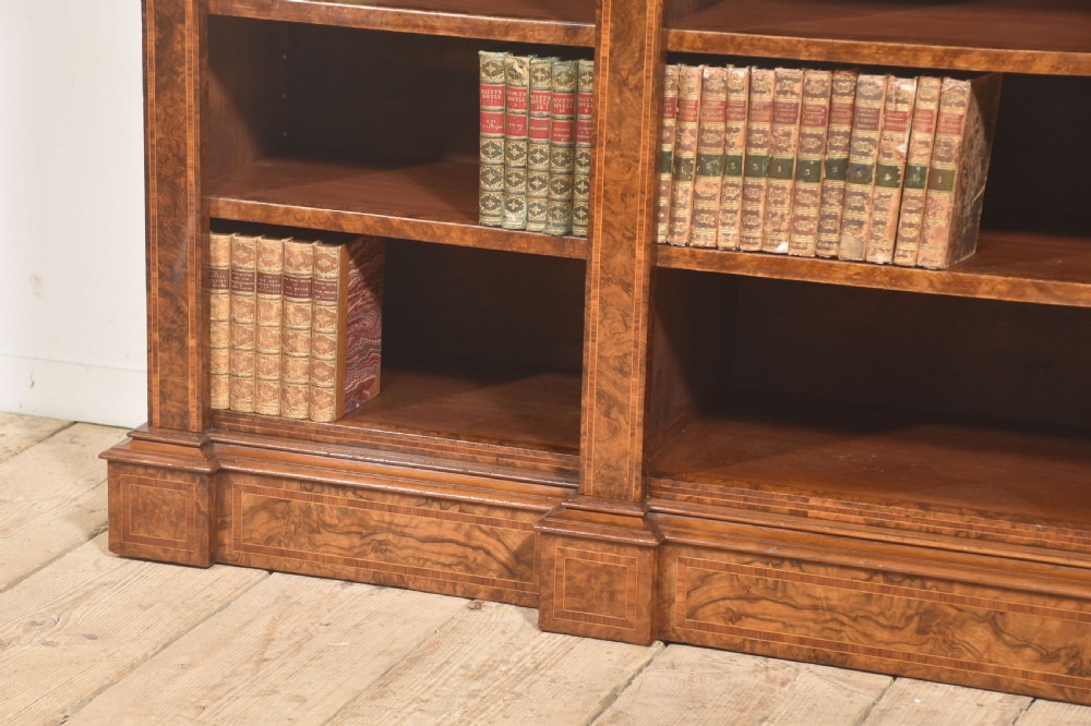 A low three-section breakfront open bookcase made from burr walnut veneer with adjustable shelves and a plinth base. View VI