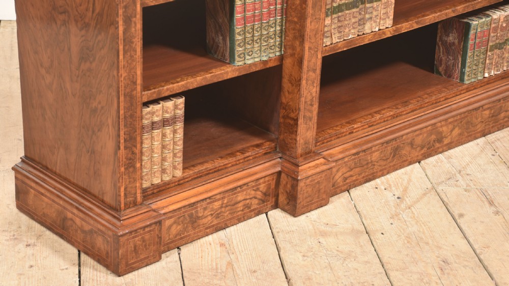 A low three-section breakfront open bookcase made from burr walnut veneer with adjustable shelves and a plinth base. View VIII