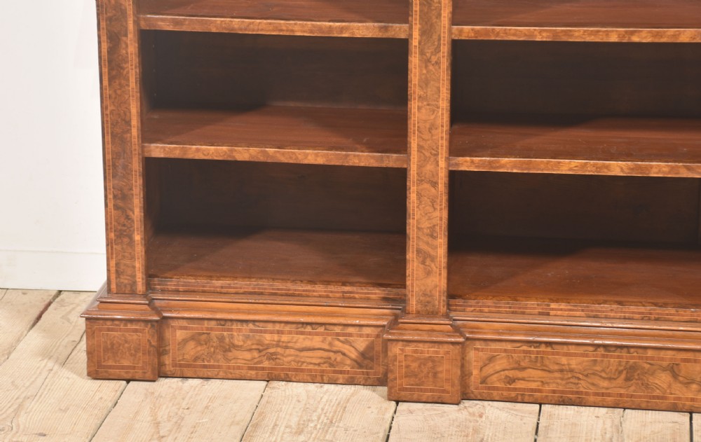 A low three-section breakfront open bookcase made from burr walnut veneer with adjustable shelves and a plinth base. View XI