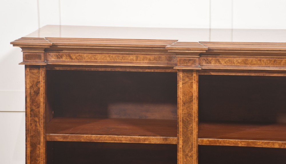 A low three-section breakfront open bookcase made from burr walnut veneer with adjustable shelves and a plinth base. View XII
