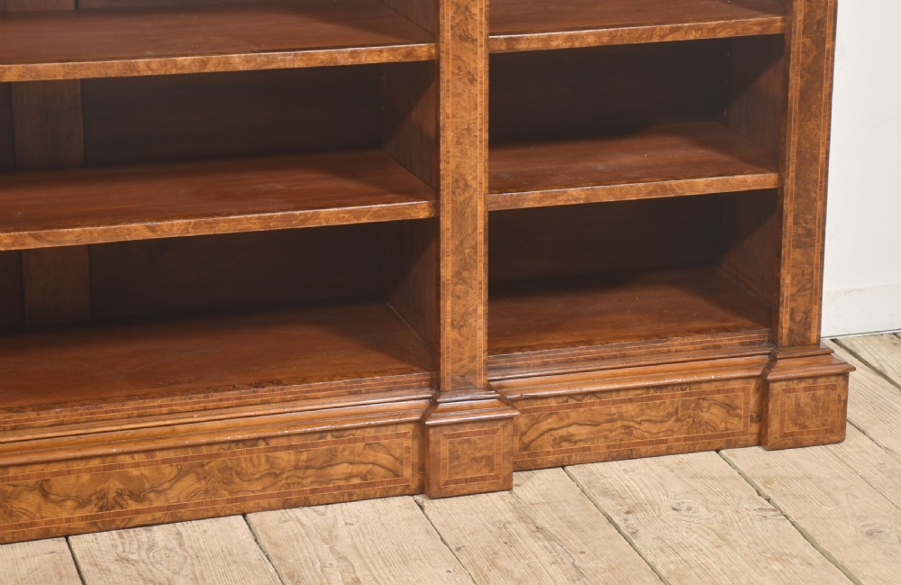 A low three-section breakfront open bookcase made from burr walnut veneer with adjustable shelves and a plinth base. View XIV
